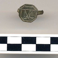 Colour photograph of a ring with engravings on it.