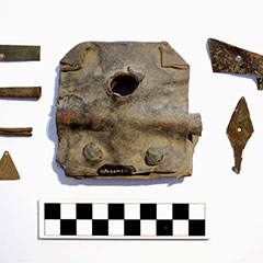 Colour photograph of seven pieces made of copper alloy. They all have different sizes and shapes.