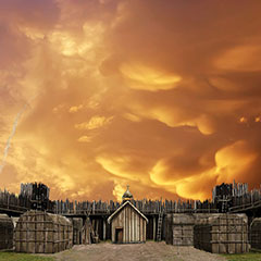 Illustration couleur de quelques maisons-longues et d'une église en bois. Le village et protégé par une palissade. Le ciel est enflammé.