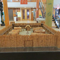 Colour photograph of the model of the Fort d'Odanak, showing miniature longhouses. The model is located in the hall of the Museum.